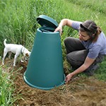 Woman and her dog opening the Green Cone outside