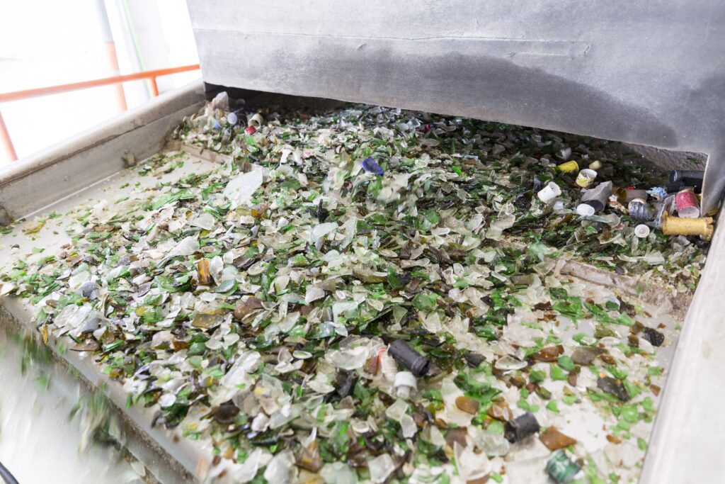 The first step: Broken glass bottles and jars at a typical MRF on their way to further sorting and crushing.