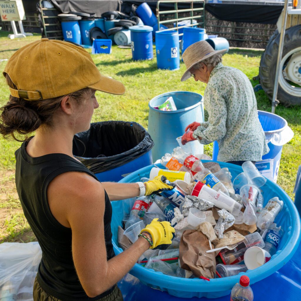 Sorting waste for recycling, organics, and trash.