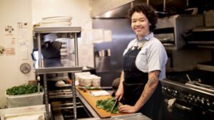 Chef cutting kale keeping food scraps to a minimum