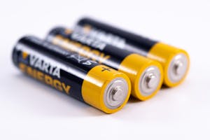 High-quality image showcasing a close-up view of three alkaline batteries on a white surface.