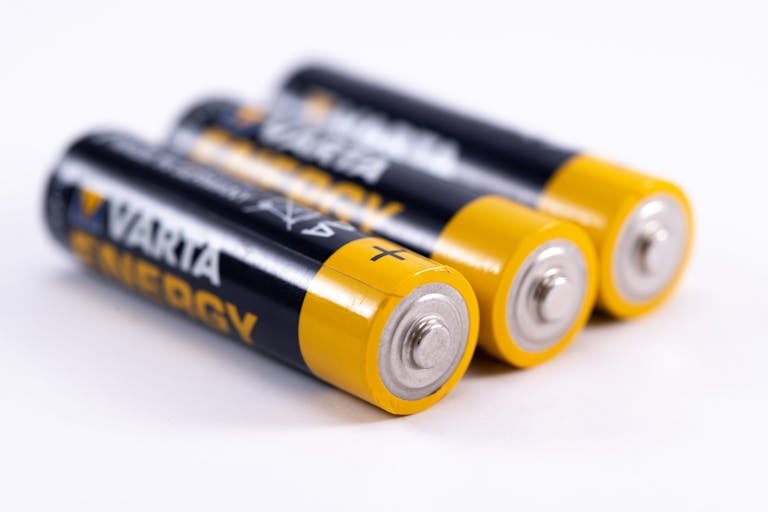 High-quality image showcasing a close-up view of three alkaline batteries on a white surface.