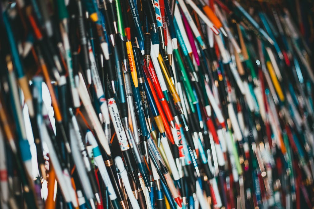 Close-up of a vibrant and diverse collection of pens hanging together, showcasing various brands and colors.